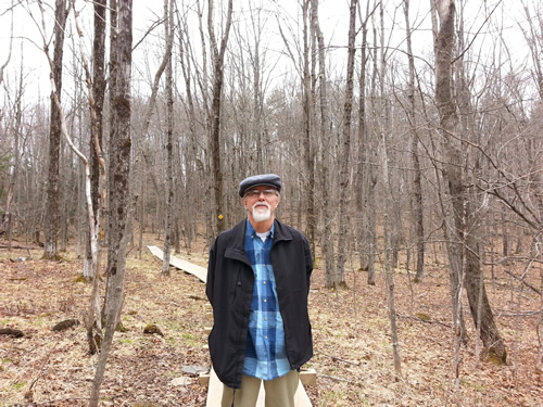 Howard Nelson standing in the woods in winter